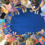 Kids standing in a ring at circle time