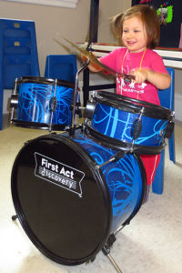 Girl banging on the drums